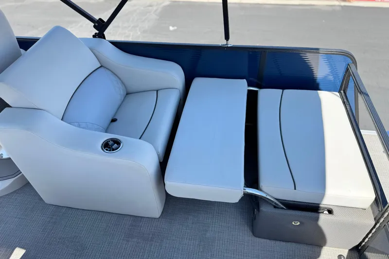 Slide: The Image of 2022 Crest Classic DLX 240 SLRC boat interior with plush seating and cup holder. - 17