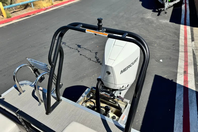 Slide: The Image of 2022 Crest Classic DLX 240 SLRC boat with Mercury outboard motor, docked on asphalt. - 18