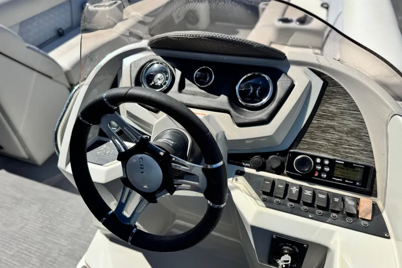 Slide: The Image of Steering console of 2022 Crest Classic DLX 240 SLRC boat with modern controls and gauges. - 21