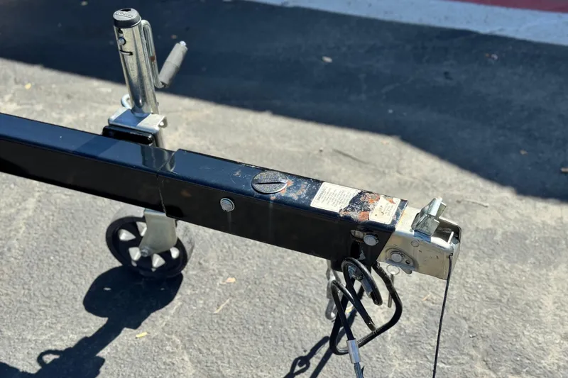 Slide: The Image of Trailer hitch of a 2022 Crest Classic DLX 240 SLRC on asphalt pavement. - 24