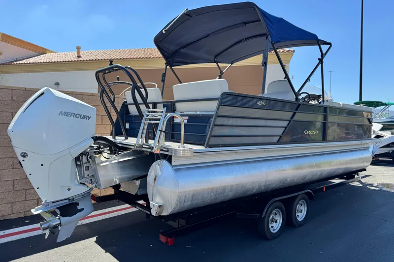 Slide: The Image of 2022 Crest Classic DLX 240 SLRC pontoon boat with Mercury engine and canopy. - 6