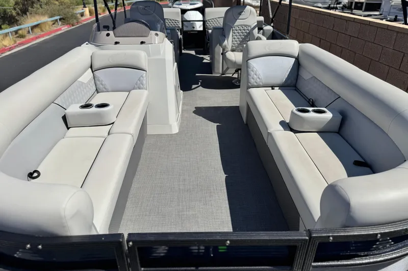 Slide: The Image of 2022 Crest Classic DLX 240 SLRC pontoon boat interior with plush seating and cup holders. - 8