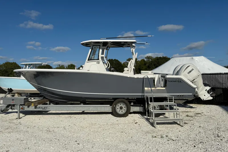 The Image of 2026 Tidewater 282 CC Adventure boat on trailer under clear blue sky. - 0