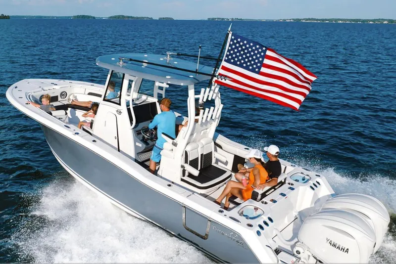 Slide: The Image of 2026 Tidewater 282 CC Adventure boat interior with dual seats and rod holders. - 11