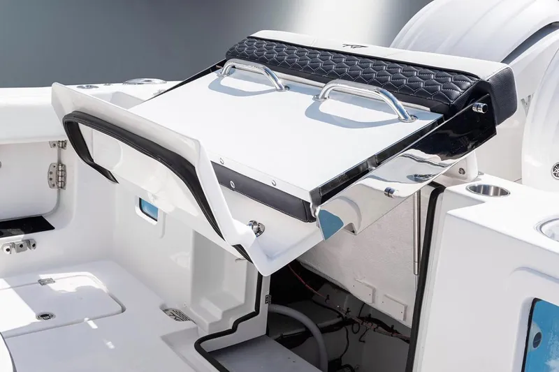 Slide: The Image of 2026 Tidewater 282 CC Adventure boat interior with seating and console, under clear blue sky. - 8