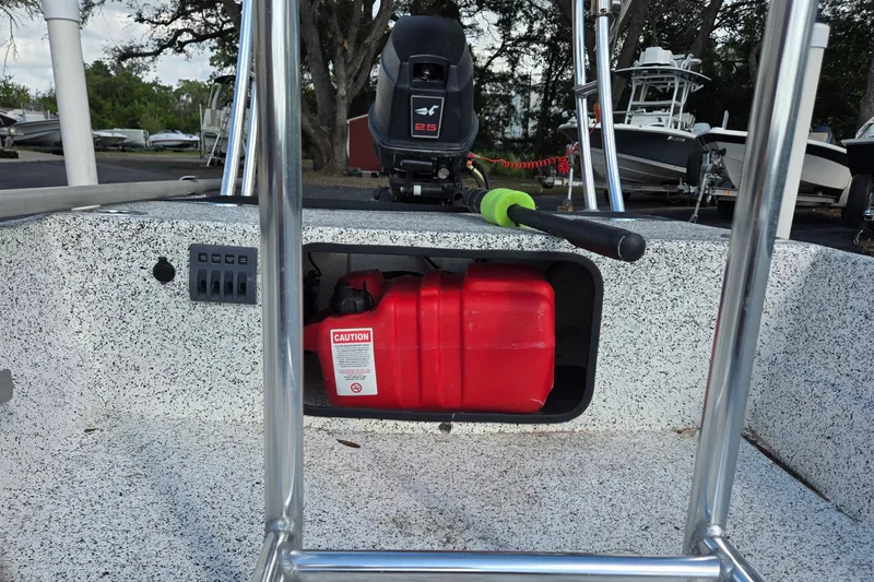 Slide: The Image of 2014 IBP 14 Skiff boat with red fuel tank and outboard motor. - 12