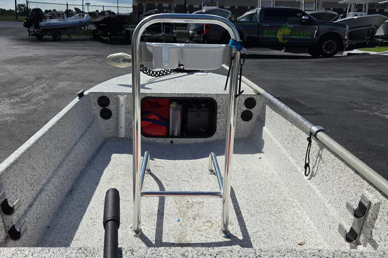 Slide: The Image of 2014 IBP 14 Skiff boat interior with storage compartment and steering console. - 14