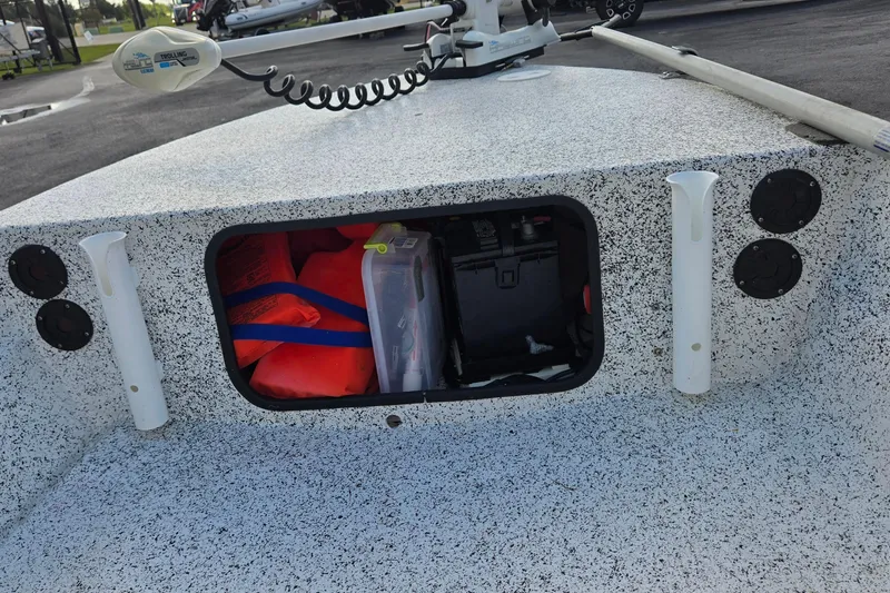 Slide: The Image of 2014 IBP 14 Skiff boat storage compartment with life jackets and gear. - 15