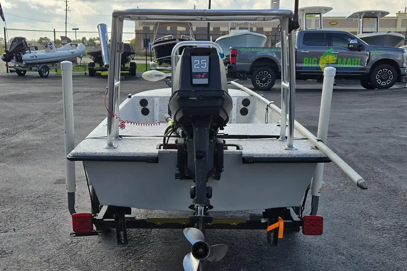 Slide: The Image of 2014 IBP 14 Skiff boat with outboard motor in a parking lot. - 4