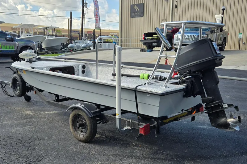 Slide: The Image of 2014 IBP 14 Skiff boat on trailer, parked outdoors near a building. - 5