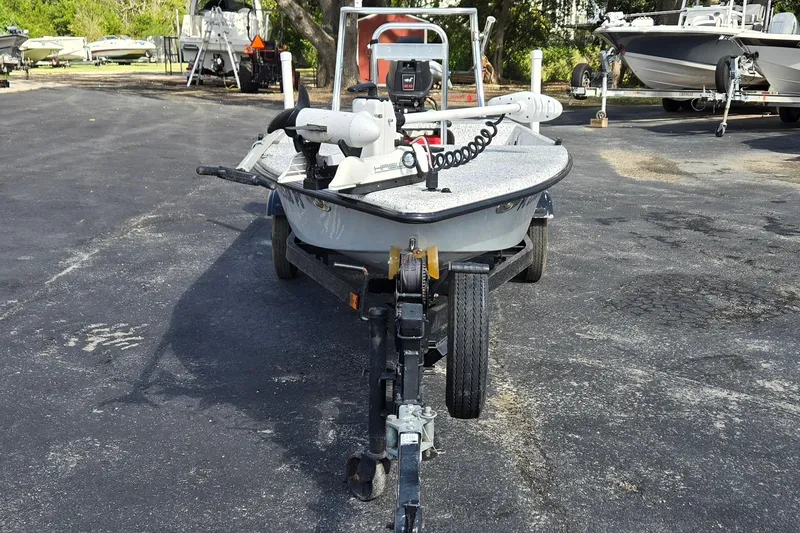 Slide: The Image of 2014 IBP 14 Skiff boat on trailer in parking lot, surrounded by other boats. - 8
