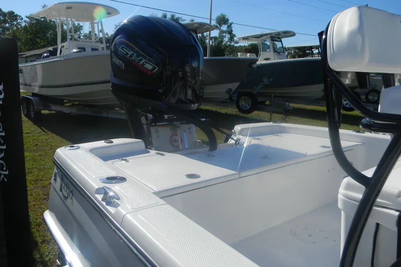 Slide: The Image of 2026 BlackJack 224 boat with powerful outboard motor, displayed outdoors. - 11