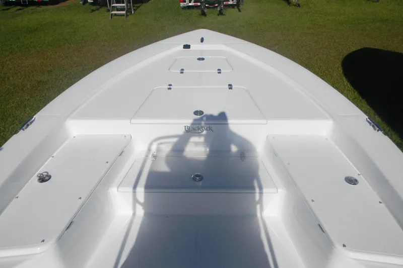 Slide: The Image of Bow view of 2026 BlackJack 224 boat, featuring spacious deck and storage compartments. - 13