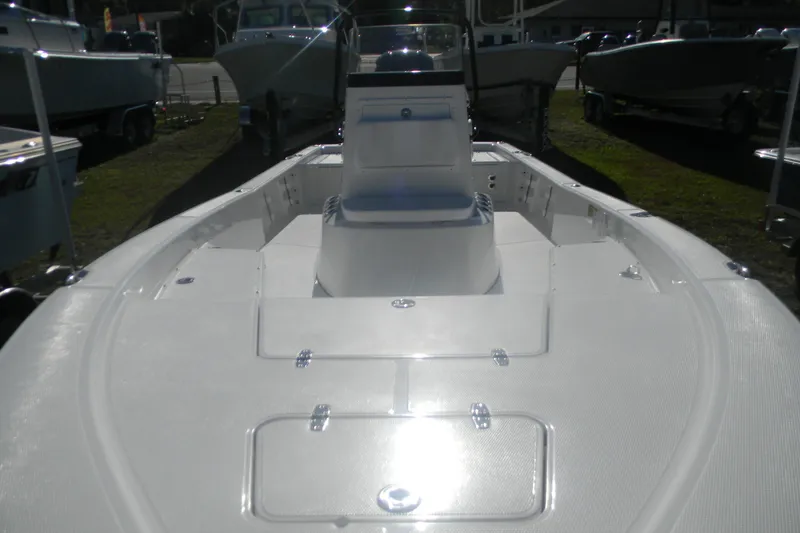 Slide: The Image of 2026 BlackJack 224 boat with spacious deck and seating, displayed outdoors. - 17