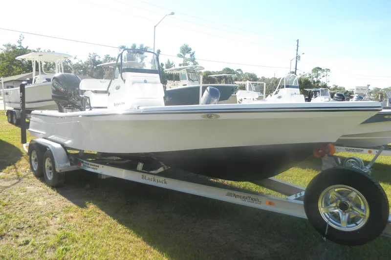 Slide: The Image of 2026 BlackJack 224 boat on trailer, parked outdoors, side view. - 8