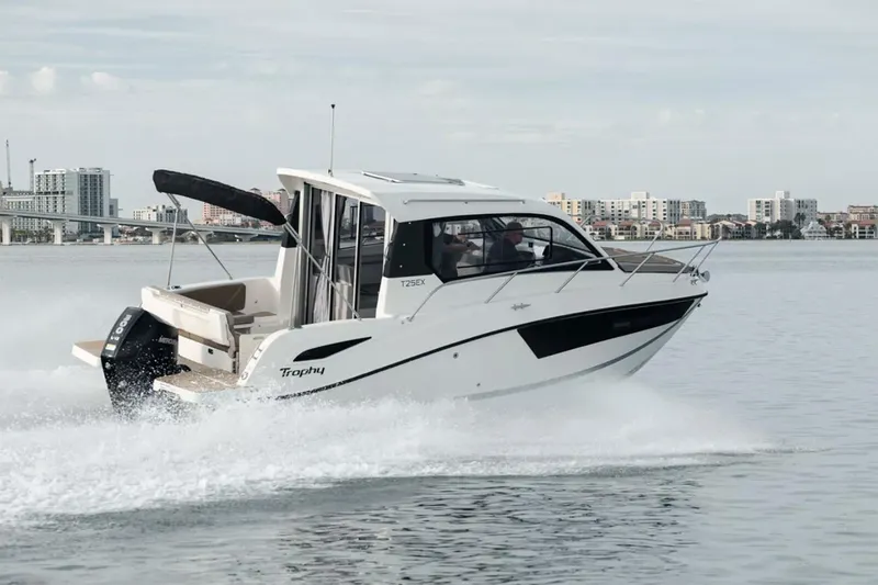 The Image of 2023 Bayliner Trophy T25 Explorer boat on trailer in warehouse setting. - 0