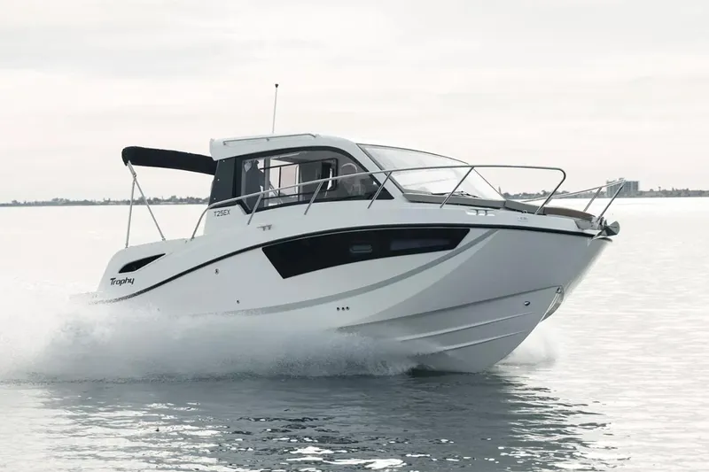 Slide: The Image of 2023 Bayliner Trophy T25 Explorer docked at marina under clear blue sky. - 1