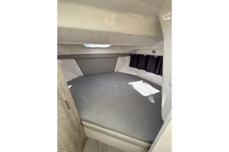 Slide: The Image of 2023 Bayliner Trophy T25 Explorer interior with seating, docked at marina. - 13