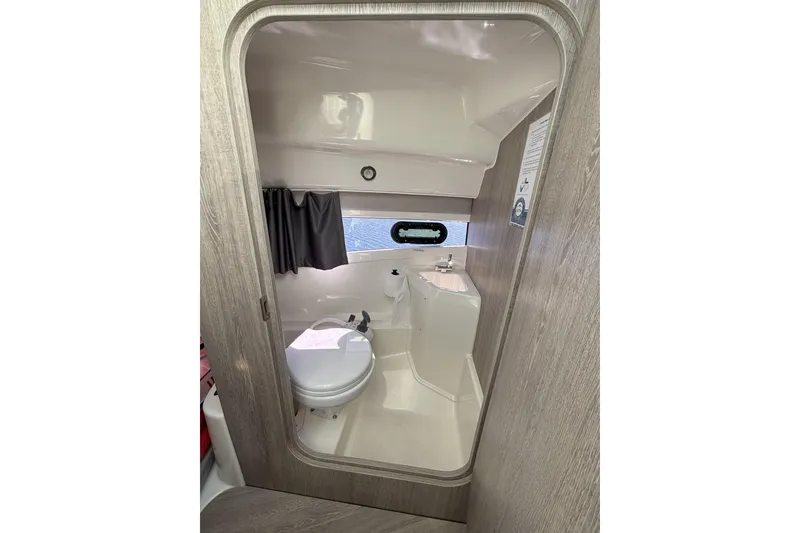 Slide: The Image of 2023 Bayliner Trophy T25 Explorer boat storage compartments with open lids. - 14