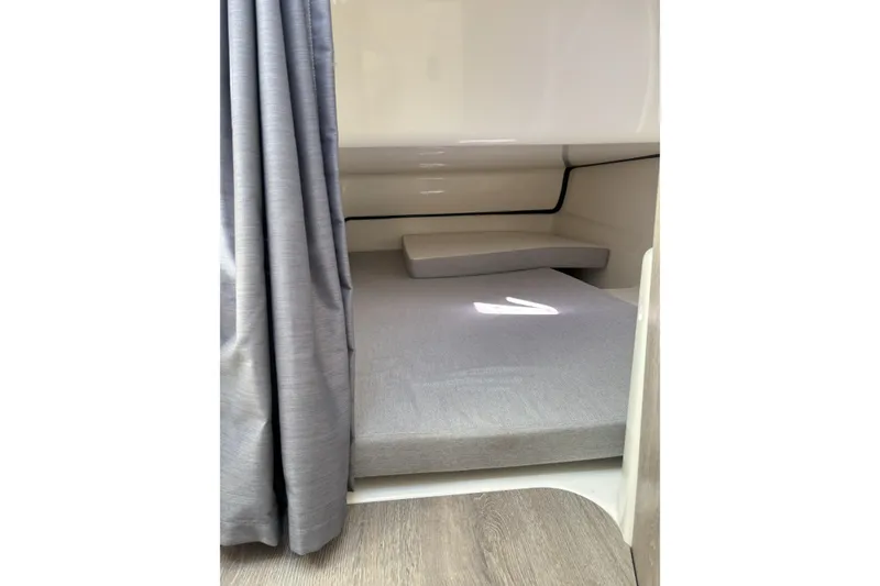 Slide: The Image of 2023 Bayliner Trophy T25 Explorer boat interior with foldable seating and storage compartments. - 15