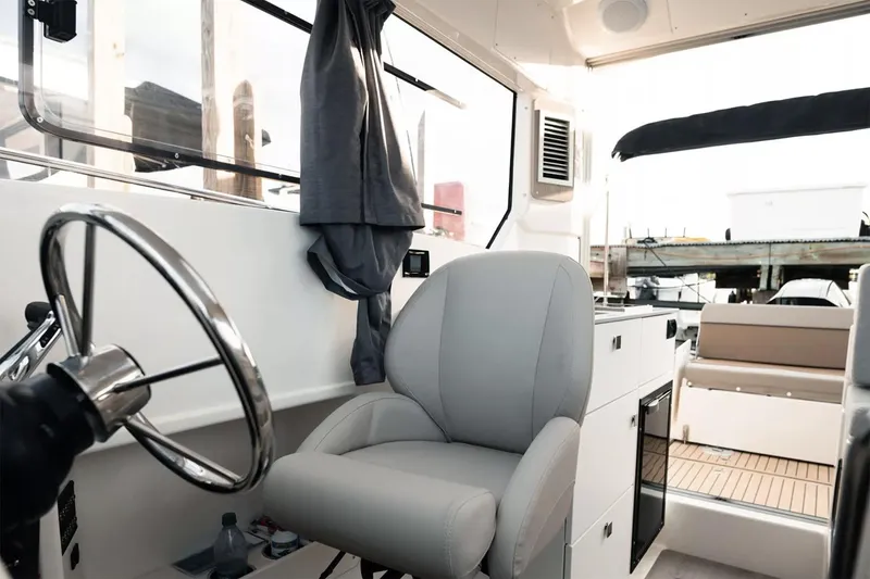 Slide: The Image of Interior of 2023 Bayliner Trophy T25 Explorer boat with seating and kitchenette. - 2