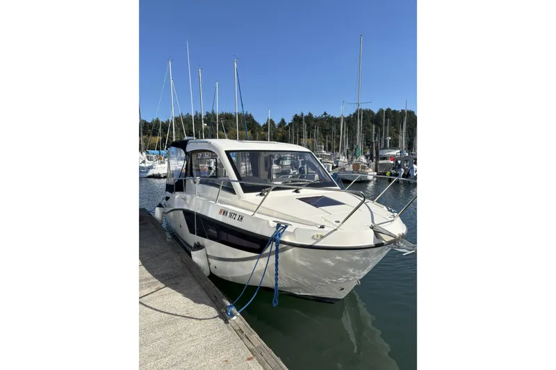 Slide: The Image of Interior of 2023 Bayliner Trophy T25 Explorer with seating and table, overlooking marina. - 3