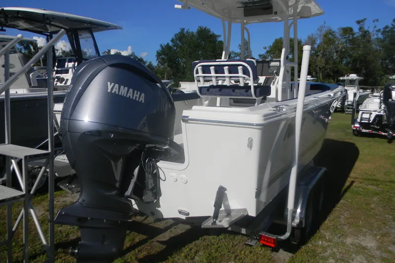 Slide: The Image of 2026 Parker 230 Coastal Elite boat with Yamaha outboard motor, displayed outdoors. - 11