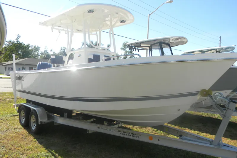 Slide: The Image of 2026 Parker 230 Coastal Elite boat on trailer, side view, outdoors. - 12