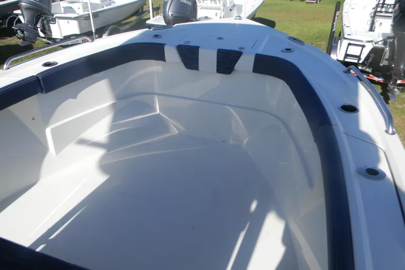 Slide: The Image of 2026 Parker 230 Coastal Elite boat interior with cushioned seating and cup holders. - 13