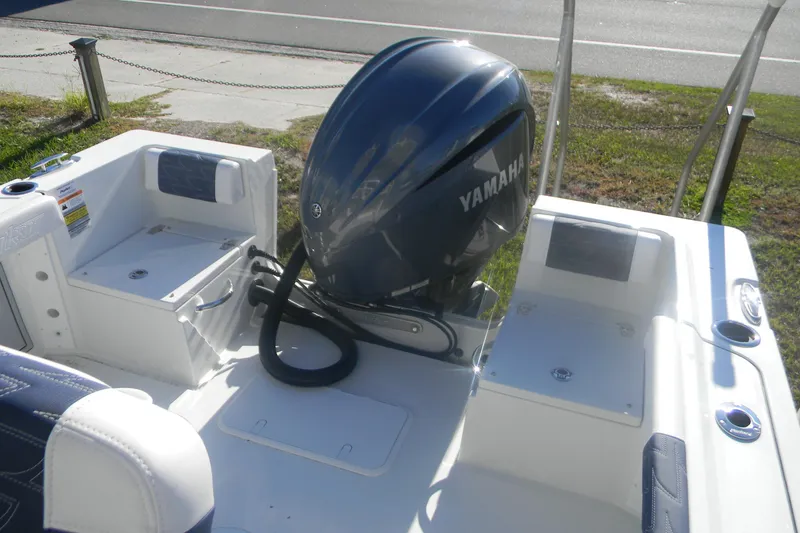 Slide: The Image of 2026 Parker 230 Coastal Elite boat with Yamaha outboard motor, featuring spacious seating. - 17