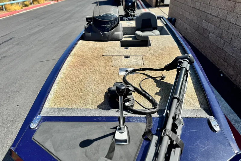 Slide: The Image of 2022 Tracker Pro 170 boat with fishing gear on deck, parked on a paved road. - 10