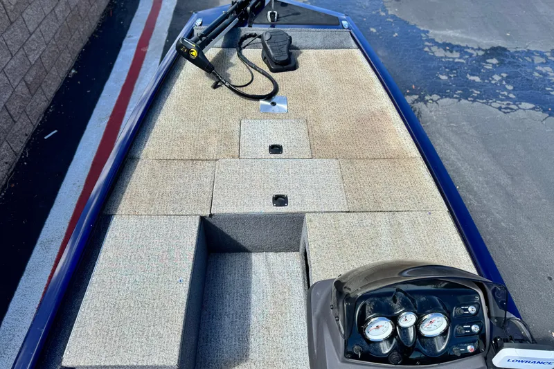 Slide: The Image of 2022 Tracker Pro 170 boat interior with control panel and carpeted deck. - 11