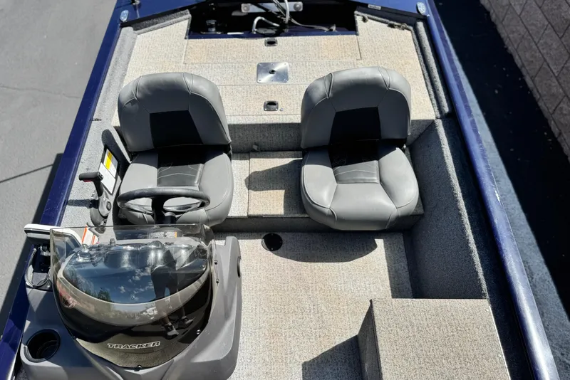 Slide: The Image of 2022 Tracker Pro 170 boat interior with two gray seats and steering console. - 15