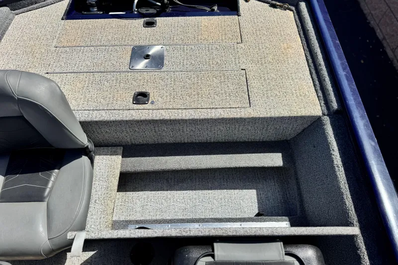 Slide: The Image of 2022 Tracker Pro 170 boat interior with gray seating and storage compartments. - 16