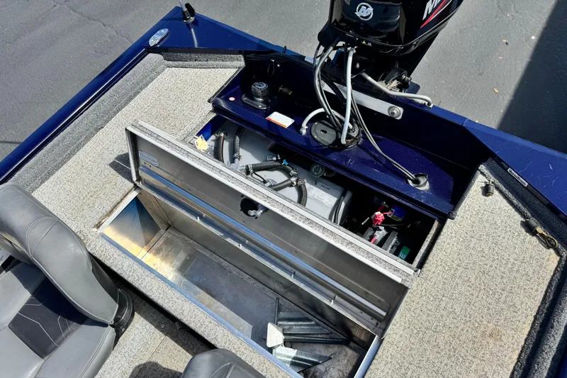 Slide: The Image of 2022 Tracker Pro 170 boat interior showing storage compartment and engine components. - 17