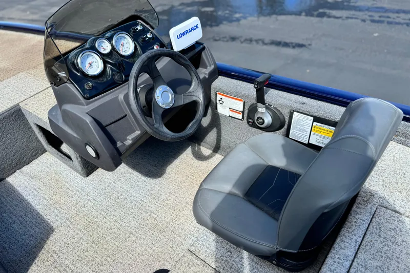 Slide: The Image of 2022 Tracker Pro 170 boat dashboard with steering wheel and gauges. - 18
