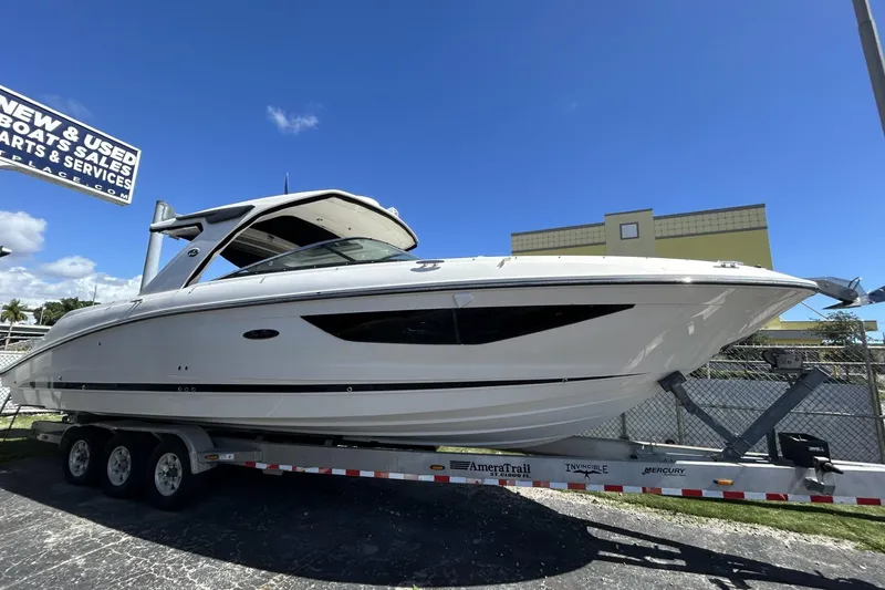 The Image of 2019 Sea Ray SLX 350 Outboard boat on trailer under clear blue sky. - 0