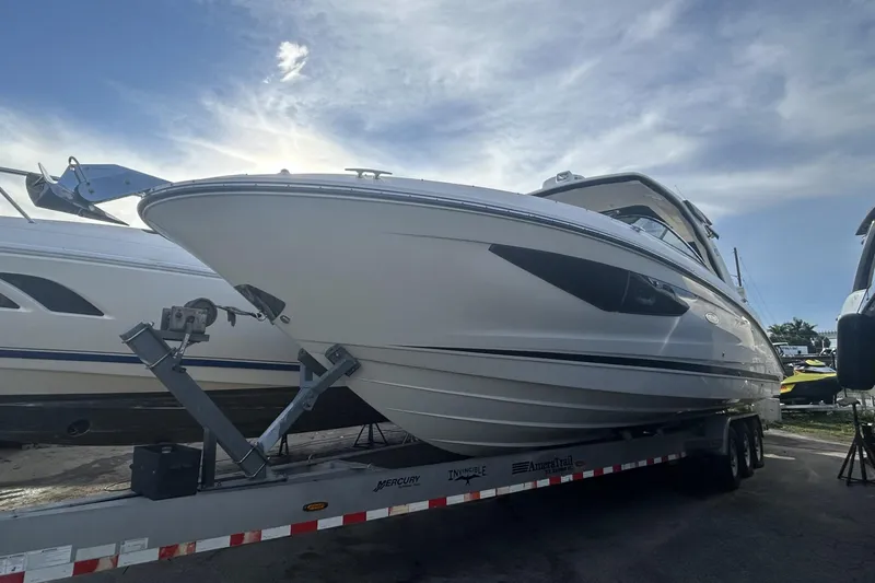Slide: The Image of 2019 Sea Ray SLX 350 Outboard boat on trailer under a cloudy sky. - 1