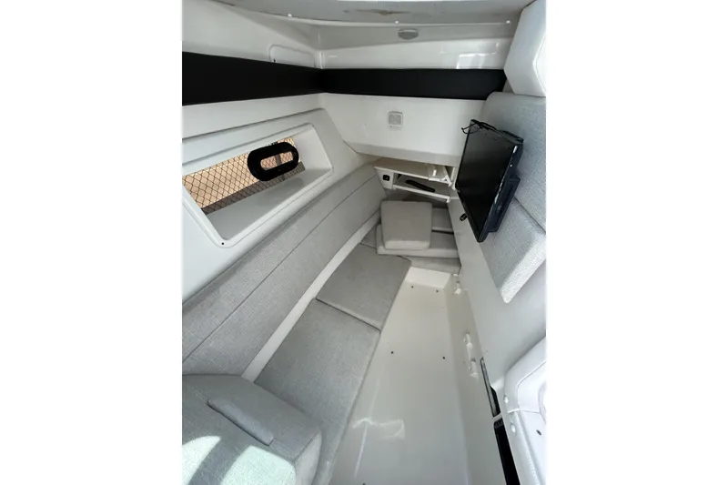 Slide: The Image of 2019 Sea Ray SLX 350 Outboard cabin interior with modern seating and window view. - 10
