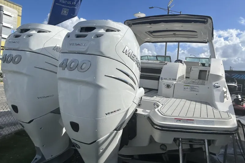 Slide: The Image of 2019 Sea Ray SLX 350 Outboard with twin Mercury Verado 400 engines, docked under blue sky. - 13