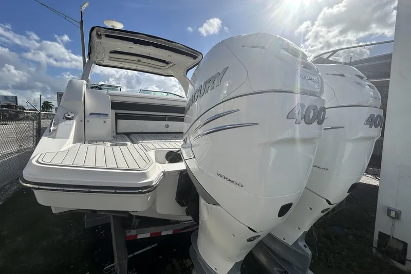 Slide: The Image of 2019 Sea Ray SLX 350 Outboard with twin Mercury 400 engines, docked under sunny skies. - 14