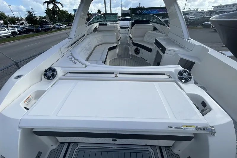 Slide: The Image of 2019 Sea Ray SLX 350 Outboard boat interior with spacious seating and modern amenities. - 16