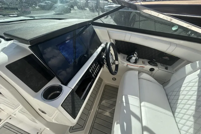 Slide: The Image of 2019 Sea Ray SLX 350 Outboard helm with modern controls and luxurious seating. - 20