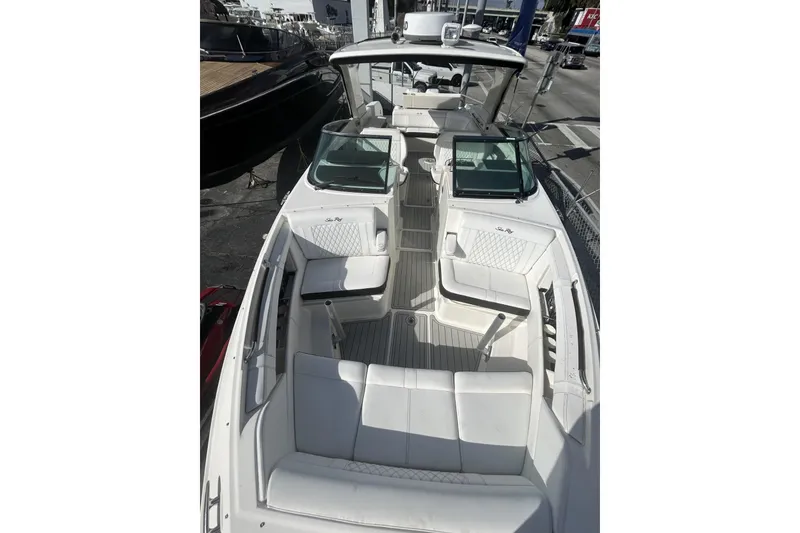 Slide: The Image of 2019 Sea Ray SLX 350 Outboard boat with spacious white seating and modern design. - 24