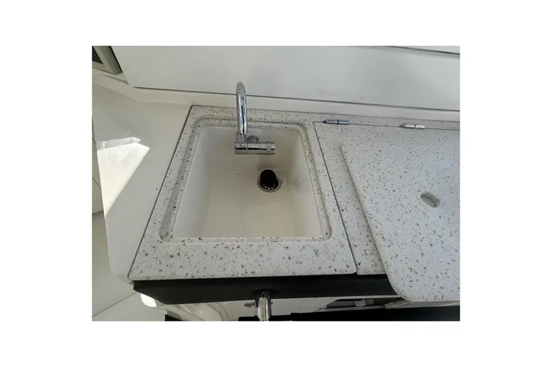 Slide: The Image of 2019 Sea Ray SLX 350 Outboard boat sink with speckled countertop. - 29