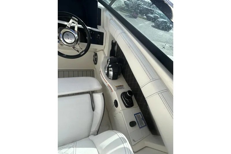 Slide: The Image of 2019 Sea Ray SLX 350 Outboard helm with steering wheel and controls. - 30