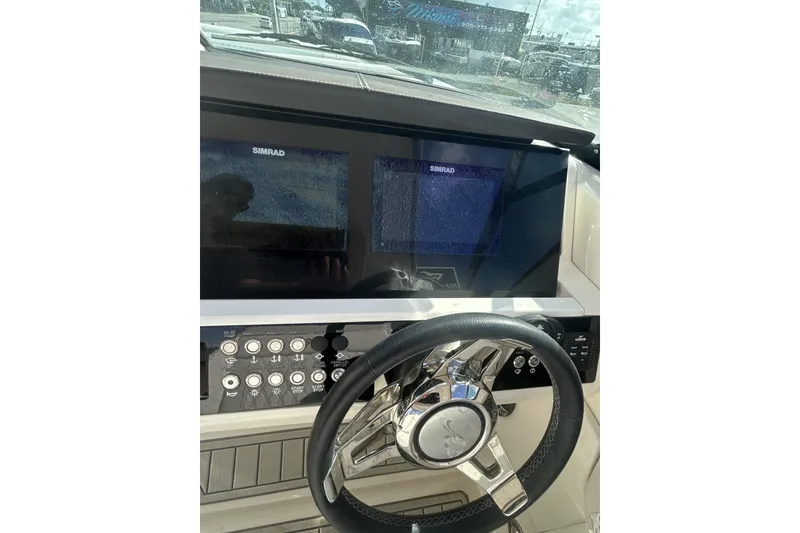 Slide: The Image of 2019 Sea Ray SLX 350 Outboard helm with Simrad displays and modern controls. - 32