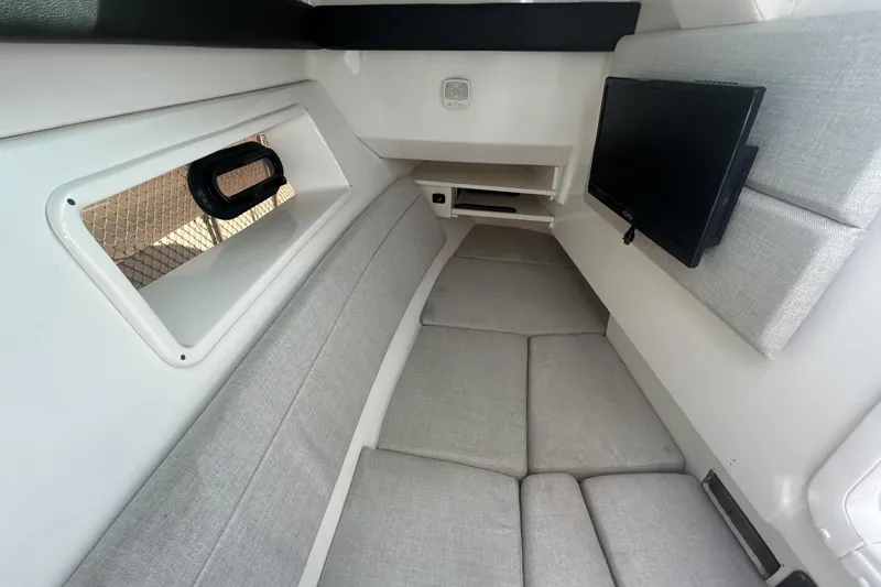 Slide: The Image of 2019 Sea Ray SLX 350 Outboard cabin interior with TV and seating. - 35