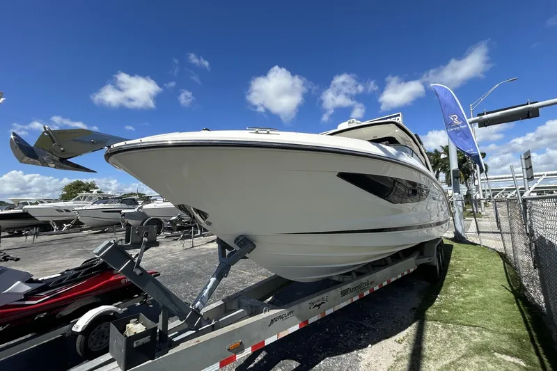 Slide: The Image of 2019 Sea Ray SLX 350 Outboard boat on trailer under clear blue sky. - 37
