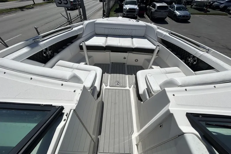 Slide: The Image of 2019 Sea Ray SLX 350 Outboard boat interior with spacious seating and modern design. - 6